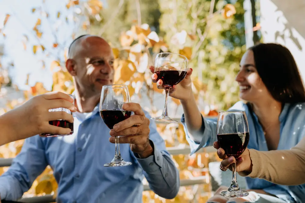 A man and woman holding wine glasses in their hands.