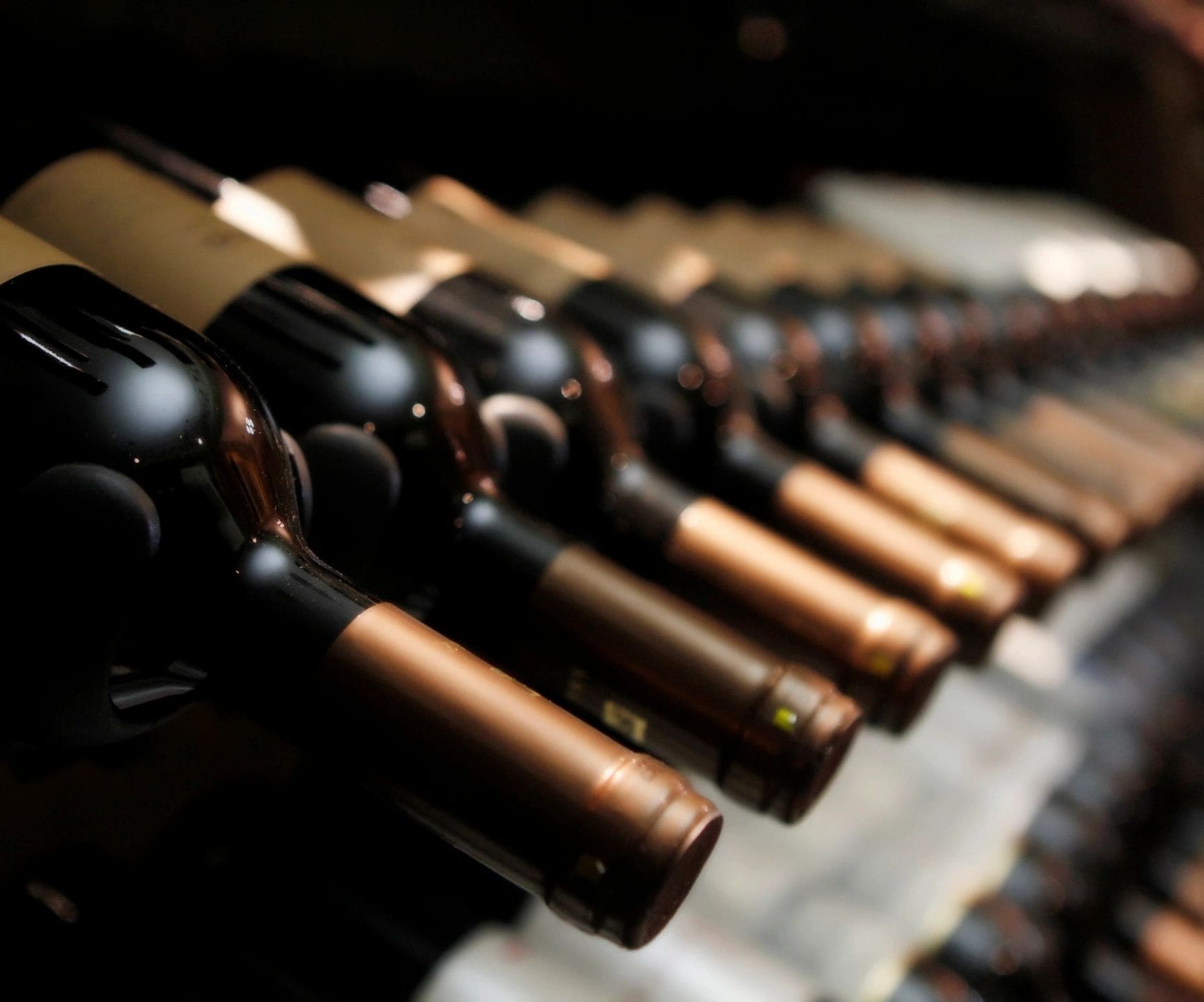 A row of bottles in a wine cellar.