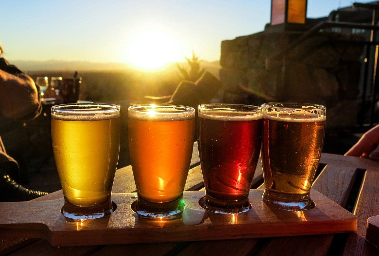 A group of beers are lined up on the table.